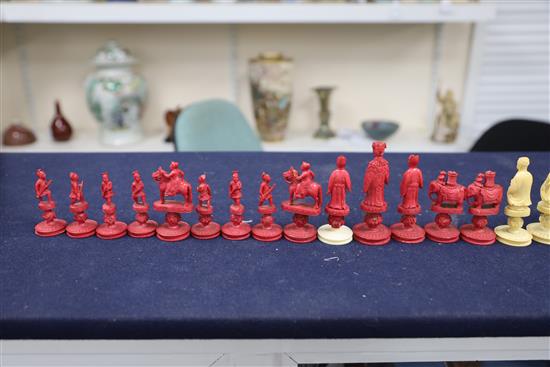 An early 19th century Chinese red stained and natural ivory rosette type chess set, kings 3.25in.